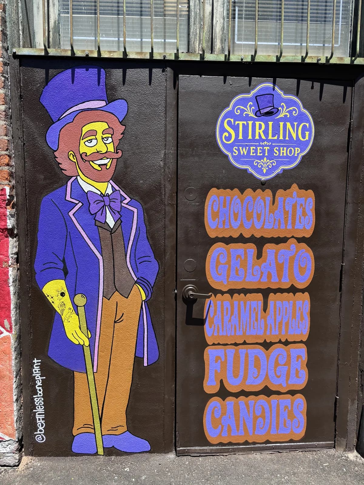 Mural of a candy-maker in a purple top hat beside the Stirling Sweet Shop sign, Freak Alley