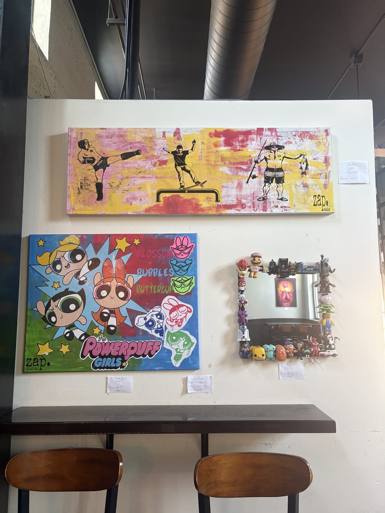 Canvases and the toy mirror hung at the show